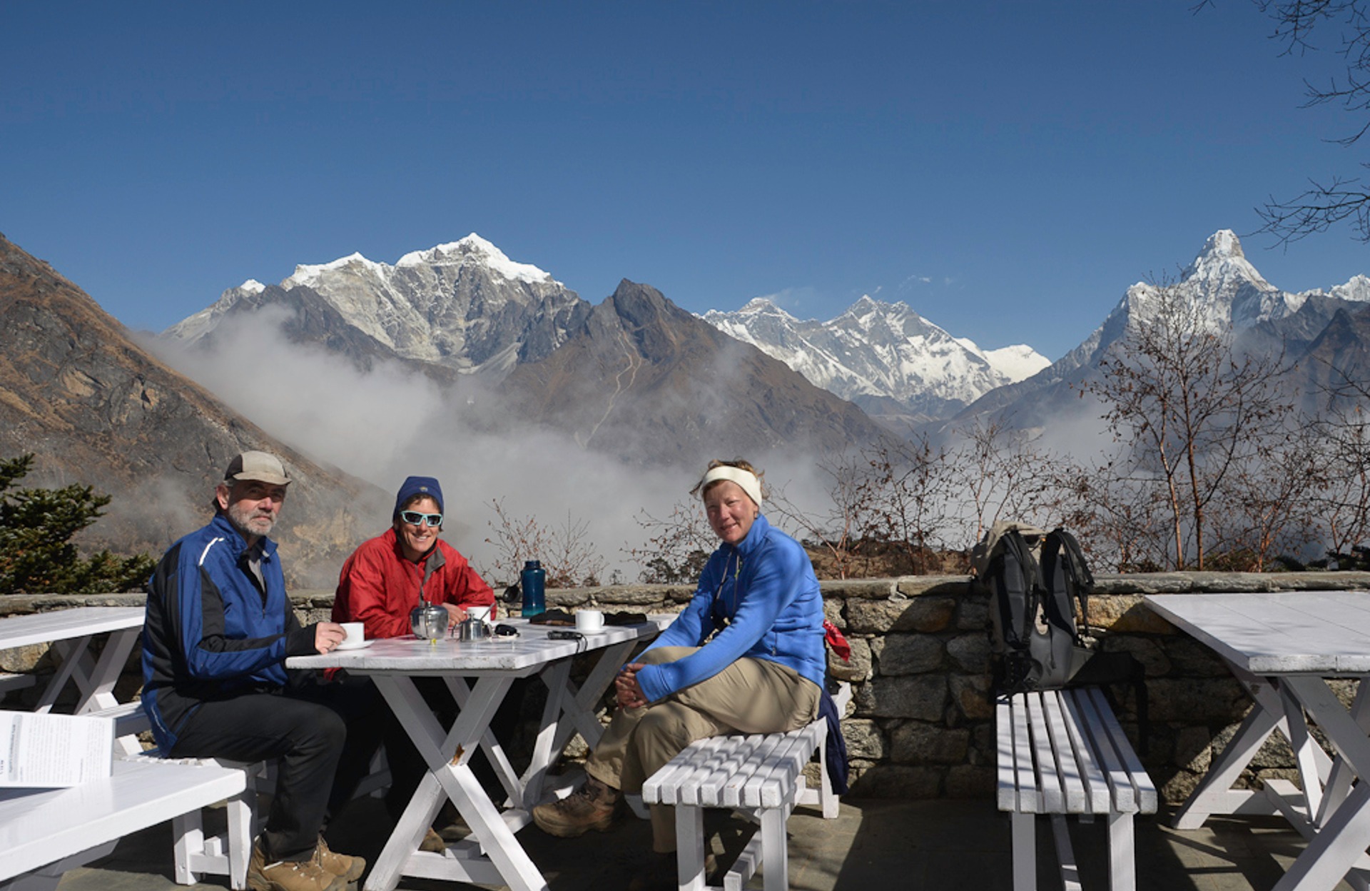 Trekkers enjoying panoramic Everest view from the terrace of Everest View Hotel.